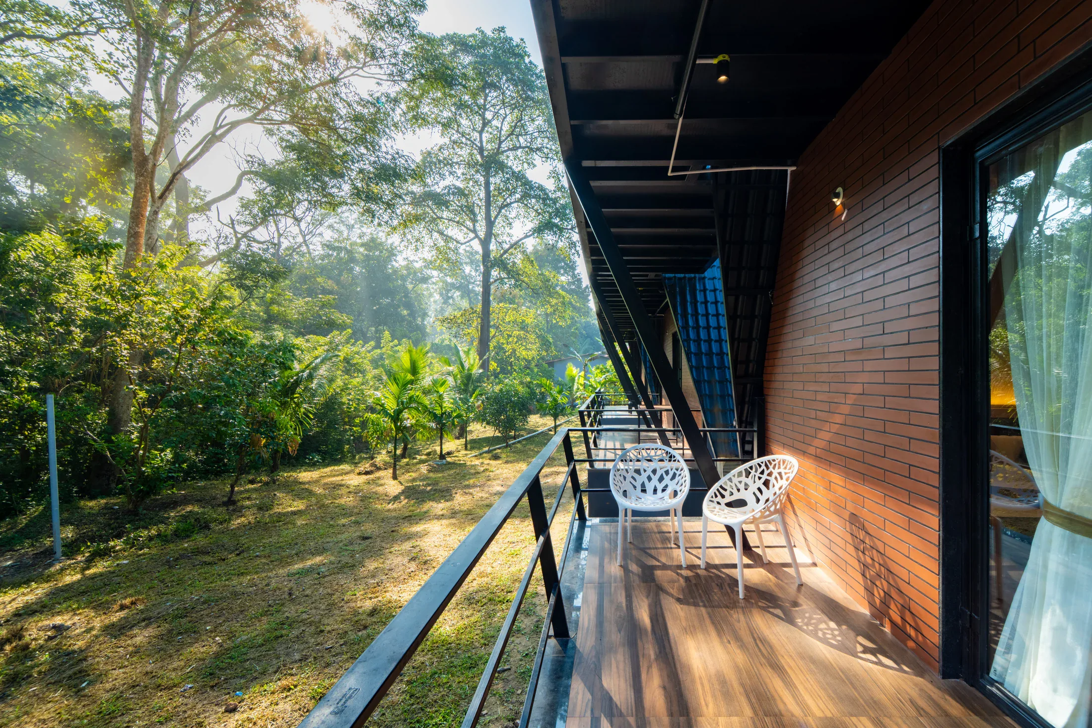 Balcony chairs looking out onto the gardens at Jungle Edge