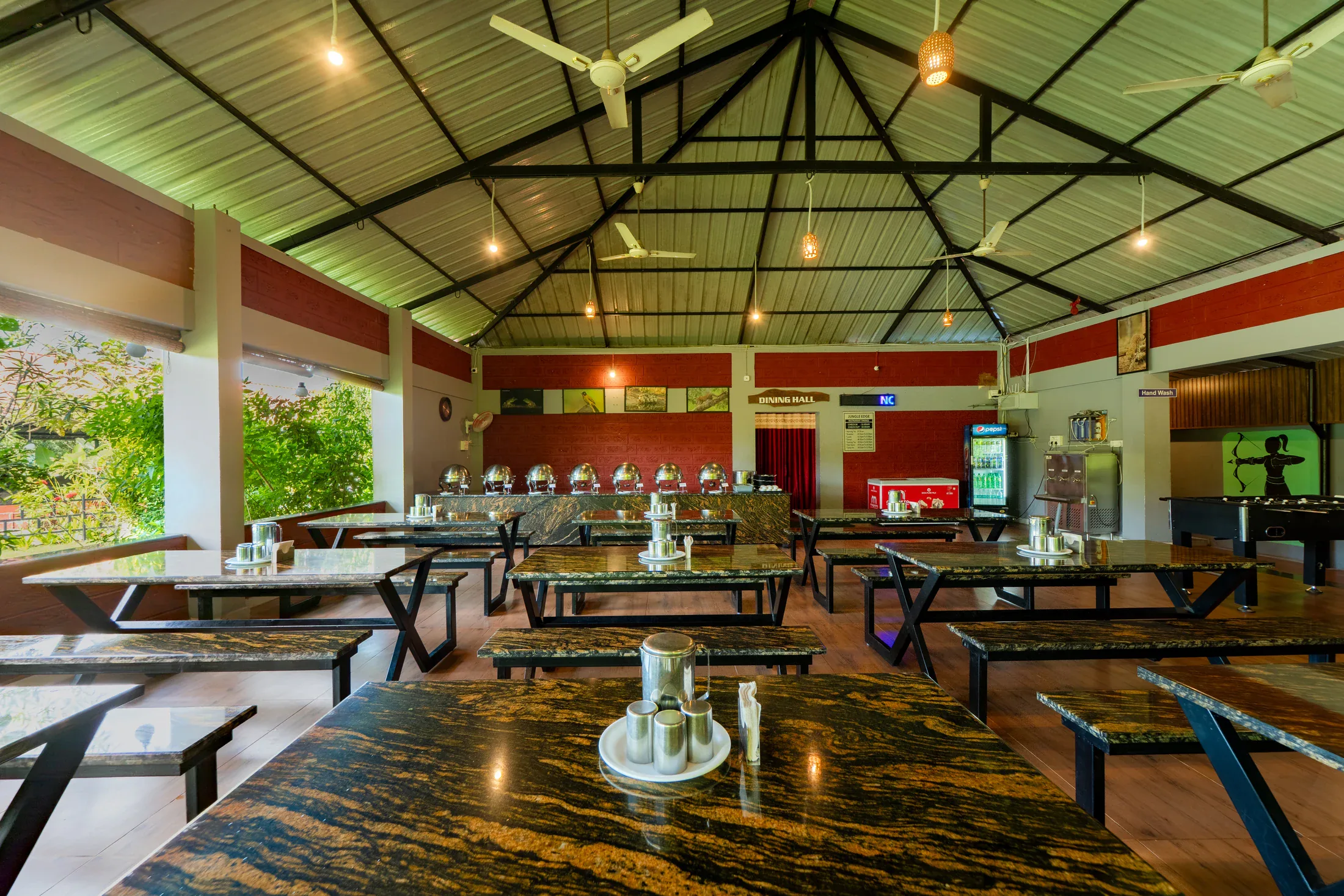 Tables in Jungle Edge’s open-sided dining area