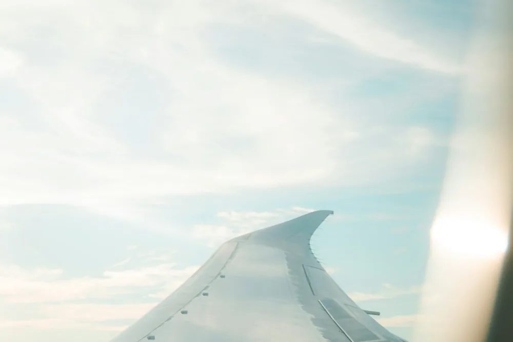 An aeroplane wing above the clouds
